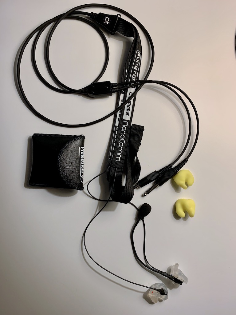 A photograph of the NanoComm GA2 headset with second set of earpieces and earpiece pouch.